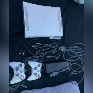 white xbox 360 comes with 2 controller and all the wires needed to operate.